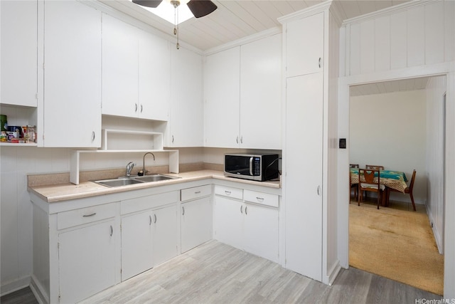 3453 Edna St, Honolulu, HI 96815 - kitchen with stainless steel microwave, open shelves, a sink, light countertops, and ceiling fan
