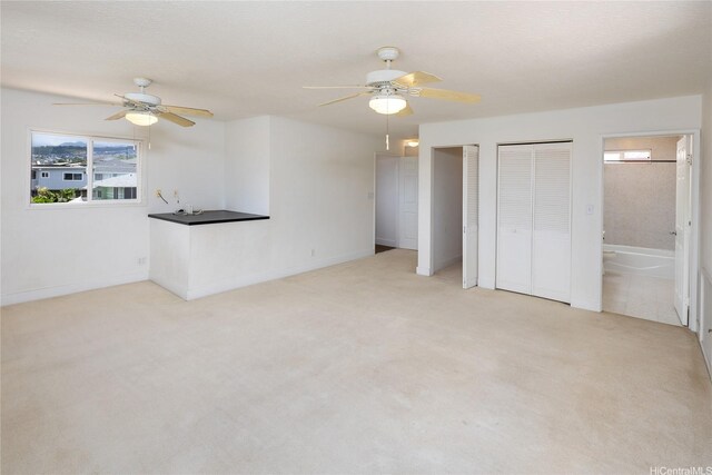 3453 Edna St, Honolulu, HI 96815 - unfurnished bedroom featuring multiple windows, light carpet, and multiple closets
