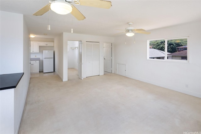 3453 Edna St, Honolulu, HI 96815 - unfurnished bedroom featuring freestanding refrigerator, light carpet, multiple closets, baseboards, and ceiling fan