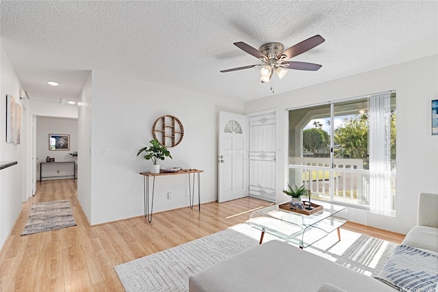 94-820 Lumiauau St Unit G201, Waipahu, HI 96797 - living room featuring light wood-style flooring, ceiling fan, and a textured ceiling