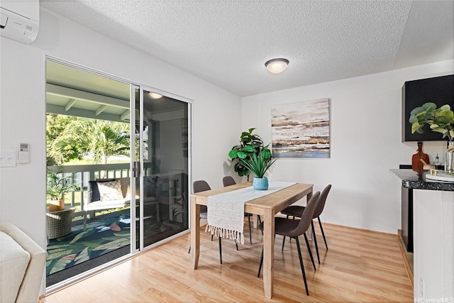 94-820 Lumiauau St Unit G201, Waipahu, HI 96797 - dining room with light wood-style floors, a textured ceiling, and an AC wall unit