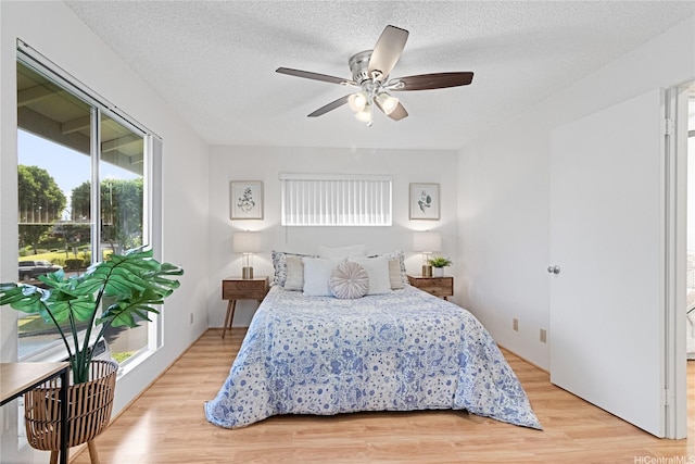 94-820 Lumiauau St Unit G201, Waipahu, HI 96797 - bedroom with multiple windows, access to exterior, light wood-style floors, and a textured ceiling