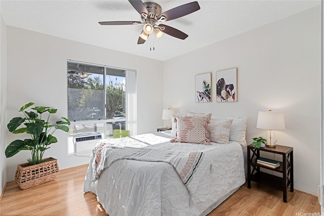 94-820 Lumiauau St Unit G201, Waipahu, HI 96797 - bedroom featuring wood finished floors, an AC wall unit, and ceiling fan