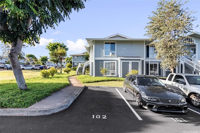 94-820 Lumiauau St Unit G201, Waipahu, HI 96797 - view of front of property with stairs, uncovered parking, and a front yard