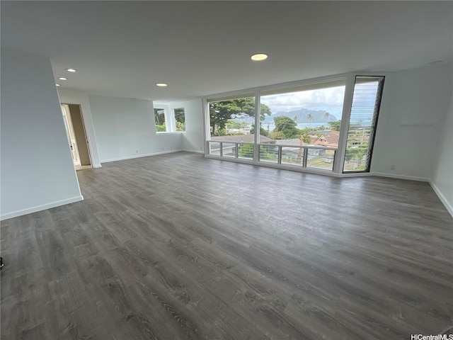 47-218 Kamehameha Hwy, Kaneohe, HI 96744 - unfurnished living room with baseboards, recessed lighting, and dark wood-style floors