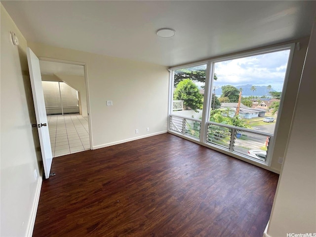 47-218 Kamehameha Hwy, Kaneohe, HI 96744 - empty room with dark wood finished floors, baseboards, and expansive windows