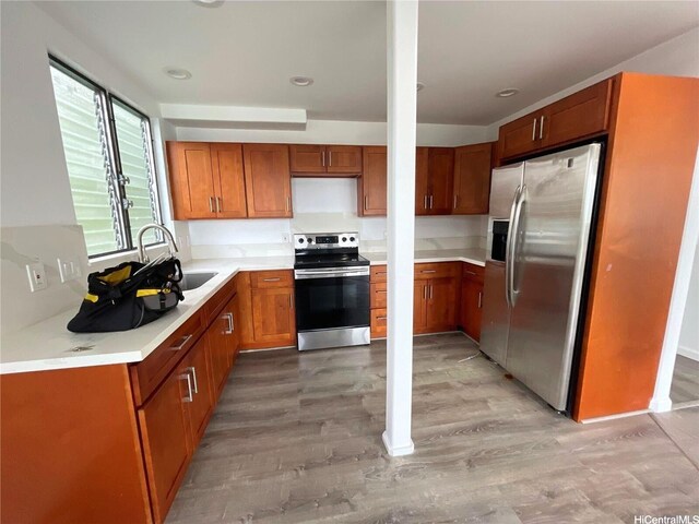 47-218 Kamehameha Hwy, Kaneohe, HI 96744 - kitchen featuring stainless steel appliances, a sink, brown cabinets, light wood finished floors, and light countertops