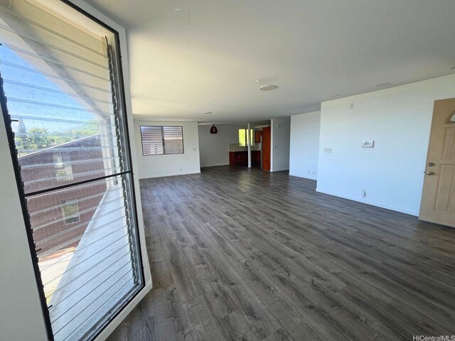 47-218 Kamehameha Hwy, Kaneohe, HI 96744 - unfurnished living room featuring dark wood-style floors and baseboards