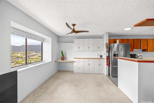 46-049 Aliianela Pl Unit 1713, Kaneohe, HI 96744 - kitchen featuring stainless steel fridge with ice dispenser, light carpet, ceiling fan, light countertops, and a textured ceiling