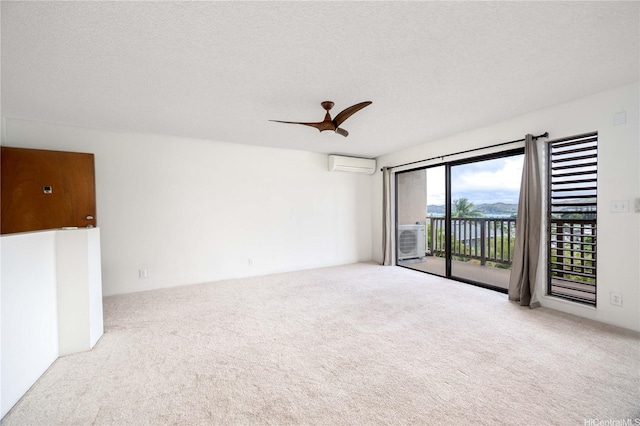 46-049 Aliianela Pl Unit 1713, Kaneohe, HI 96744 - carpeted spare room with an AC wall unit, a textured ceiling, and ceiling fan