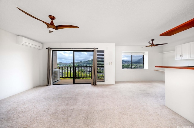 46-049 Aliianela Pl Unit 1713, Kaneohe, HI 96744 - unfurnished living room featuring a ceiling fan, an AC wall unit, and plenty of natural light