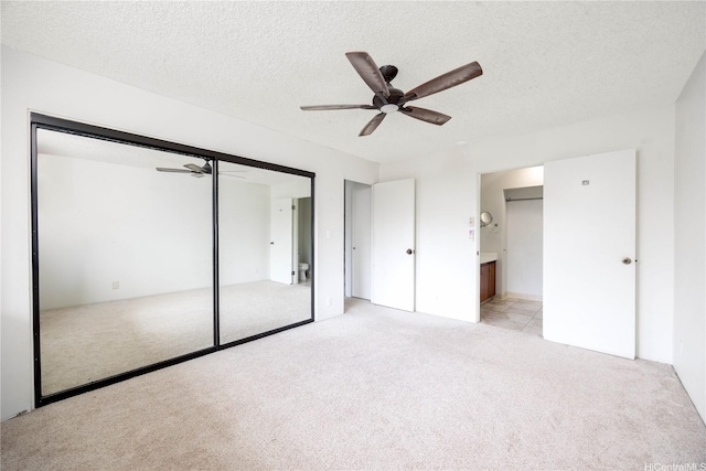 46-049 Aliianela Pl Unit 1713, Kaneohe, HI 96744 - unfurnished bedroom with light colored carpet, a textured ceiling, a closet, and ceiling fan