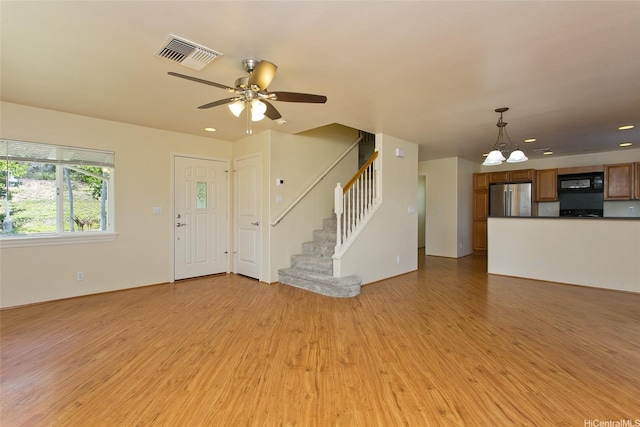 87-2233 Pakeke St, Waianae, HI 96792 - unfurnished living room with light wood-style floors, a ceiling fan, stairway, recessed lighting, and a chandelier