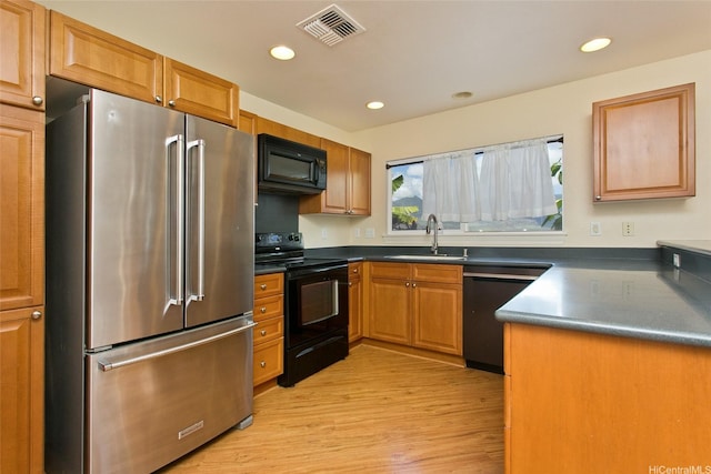 87-2233 Pakeke St, Waianae, HI 96792 - kitchen with black appliances, a sink, light wood-style floors, dark countertops, and recessed lighting