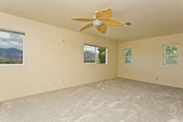 87-2233 Pakeke St, Waianae, HI 96792 - empty room featuring healthy amount of natural light, carpet flooring, and a ceiling fan