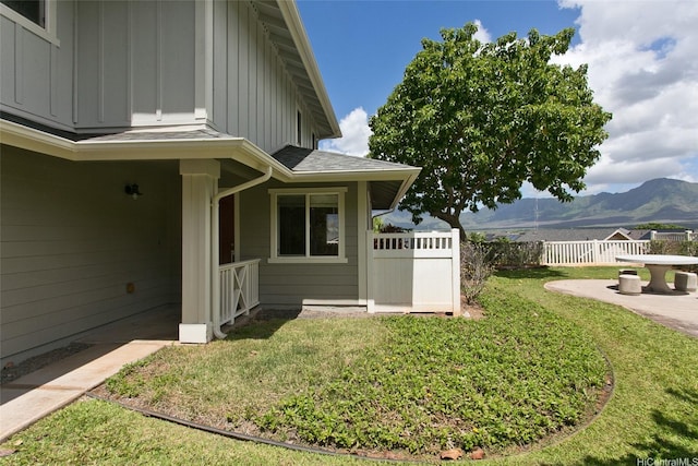 87-2233 Pakeke St, Waianae, HI 96792 - view of home's exterior with board and batten siding, a mountain view, roof with shingles, and a patio