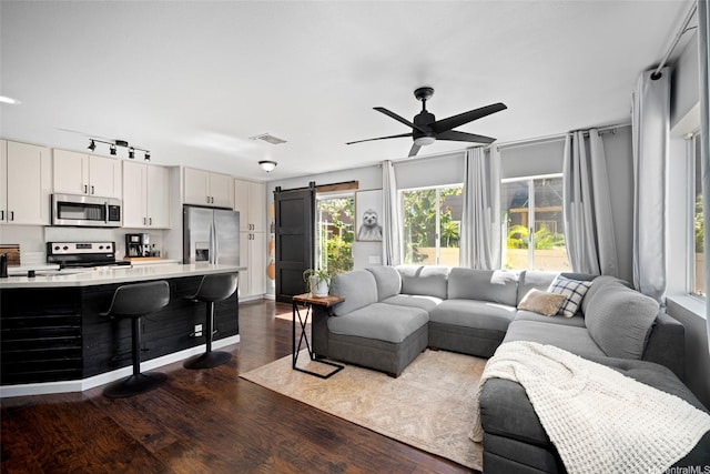 91-422 Makalea St Unit 94, Ewa Beach, HI 96706 - living area featuring dark wood-type flooring, ceiling fan, and a barn door