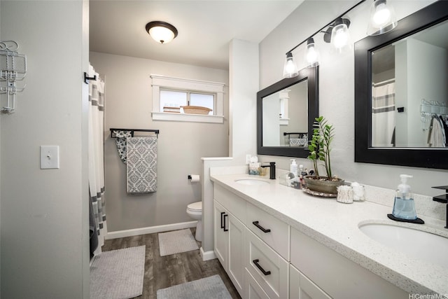 91-422 Makalea St Unit 94, Ewa Beach, HI 96706 - full bathroom featuring wood finished floors, toilet, double vanity, and baseboards