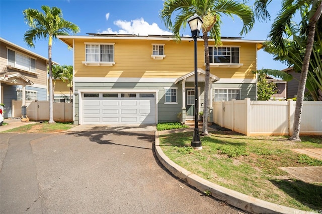 91-422 Makalea St Unit 94, Ewa Beach, HI 96706 - traditional-style house featuring a garage, driveway, fence, and solar panels