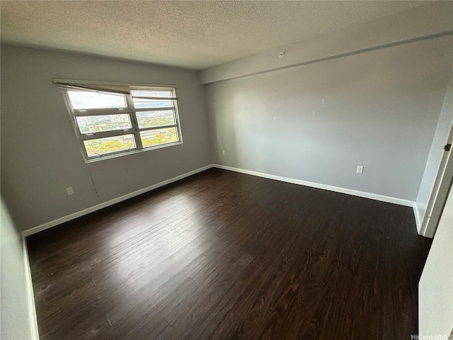 801 S St Unit 1723, Honolulu, HI 96813 - unfurnished room with dark wood-style flooring, a textured ceiling, and baseboards