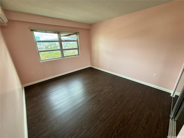 801 S St Unit 1723, Honolulu, HI 96813 - spare room featuring dark wood-type flooring, baseboards, and a textured ceiling