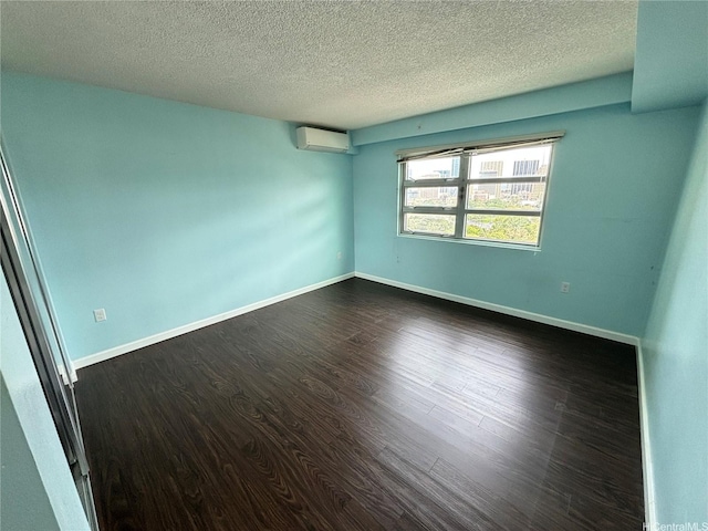 801 S St Unit 1723, Honolulu, HI 96813 - unfurnished room with a wall unit AC, dark wood finished floors, a textured ceiling, and baseboards