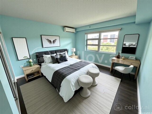 801 S St Unit 1723, Honolulu, HI 96813 - bedroom with an AC wall unit, a textured ceiling, baseboards, and wood finished floors