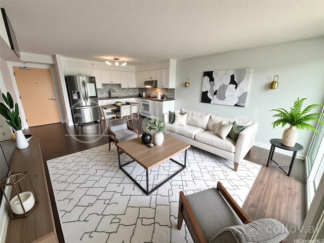 801 S St Unit 1723, Honolulu, HI 96813 - living room with wood finished floors, baseboards, and a textured ceiling