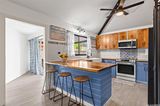 94-265 Anania Dr, Mililani, HI 96789 - kitchen with stainless steel appliances, wooden counters, light wood-type flooring, and tasteful backsplash