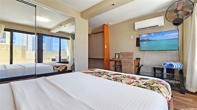 2425 Kuhio Ave Unit 1401, Honolulu, HI 96815 - bedroom featuring access to outside, a wall unit AC, and wood finished floors