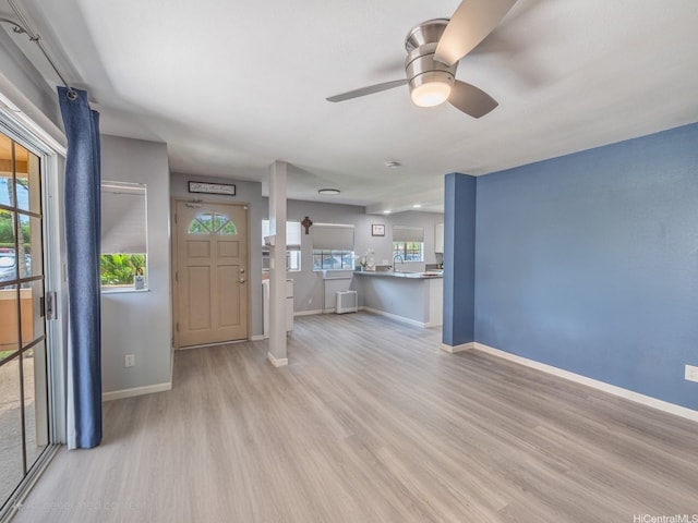 91-1066 Makaaloa St Unit 14D, Ewa Beach, HI 96706 - unfurnished living room with wood finished floors, baseboards, a ceiling fan, and a sink
