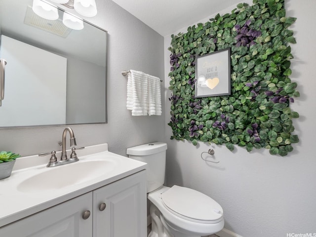 91-1066 Makaaloa St Unit 14D, Ewa Beach, HI 96706 - half bathroom featuring toilet, vanity, and a textured wall
