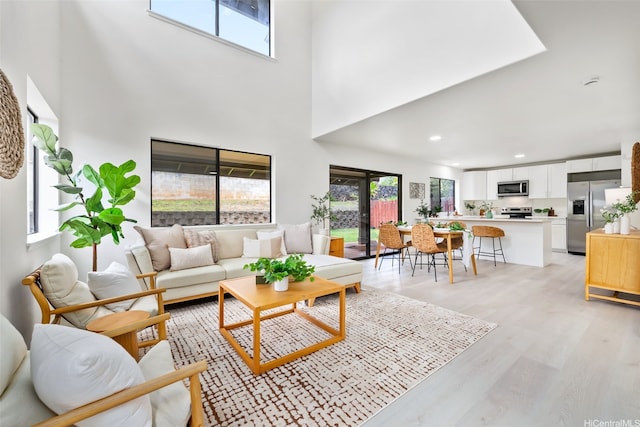 95-1204 Moea St Unit 48, Mililani, HI 96789 - living area with healthy amount of natural light, a towering ceiling, light wood finished floors, and recessed lighting