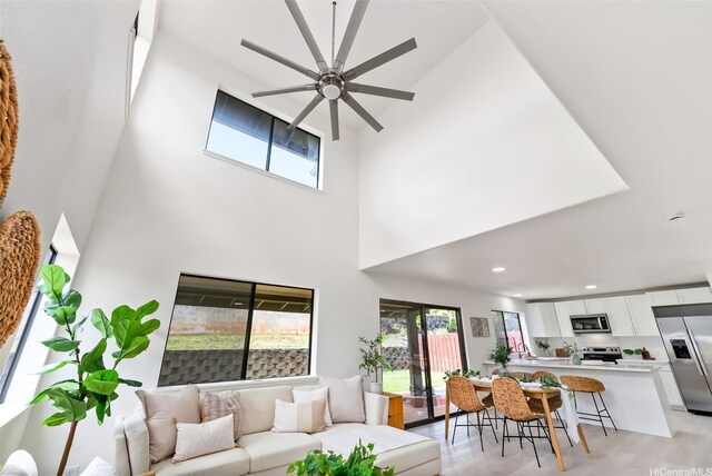 95-1204 Moea St Unit 48, Mililani, HI 96789 - living area featuring ceiling fan, plenty of natural light, a high ceiling, light wood-style floors, and recessed lighting