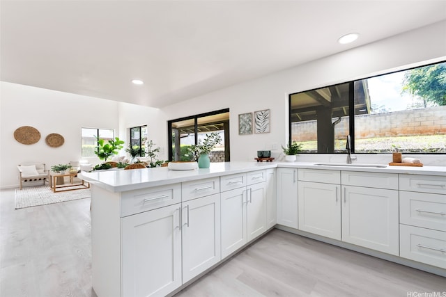 95-1204 Moea St Unit 48, Mililani, HI 96789 - kitchen with a sink, light wood-style floors, a peninsula, light countertops, and recessed lighting