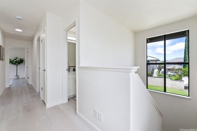 95-1204 Moea St Unit 48, Mililani, HI 96789 - corridor featuring an upstairs landing, light wood finished floors, attic access, and baseboards