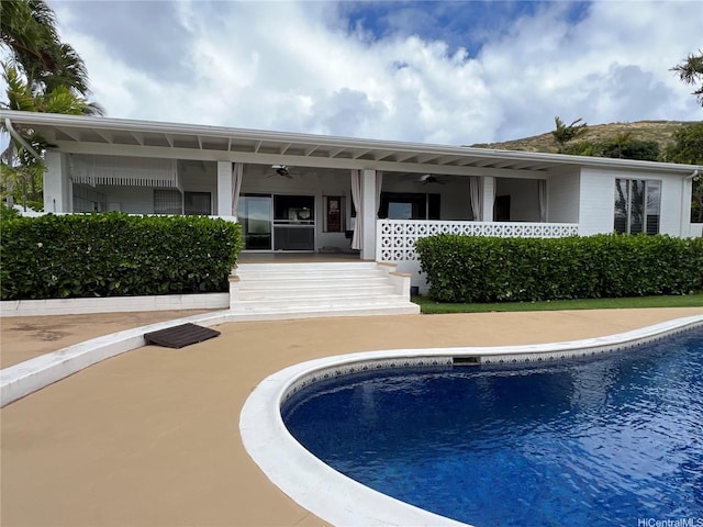 118 Kalalau St, Honolulu, HI 96825 - rear view of property featuring ceiling fan and an outdoor pool