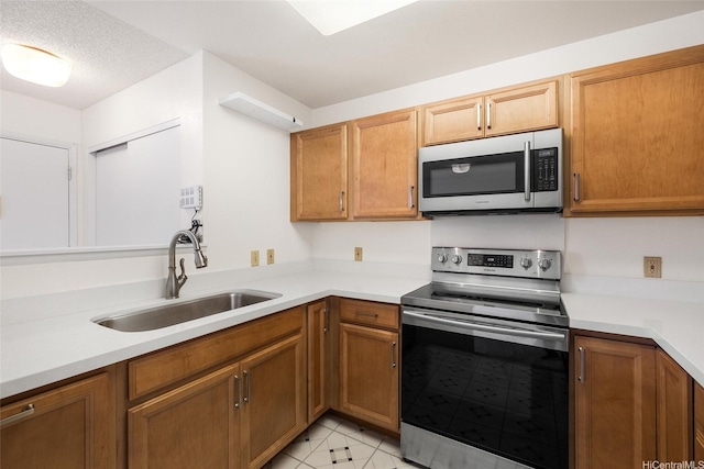 95-1059 Koolani Dr Unit 4, Mililani, HI 96789 - kitchen with appliances with stainless steel finishes, a sink, light countertops, and brown cabinets