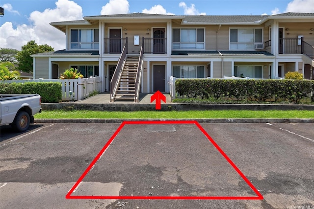 95-1059 Koolani Dr Unit 4, Mililani, HI 96789 - view of property with stairs, uncovered parking, and fence