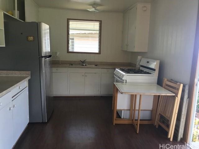 3031 Libert St, Honolulu, HI 96816 - kitchen with dark wood finished floors, white cabinetry, and white range with gas cooktop
