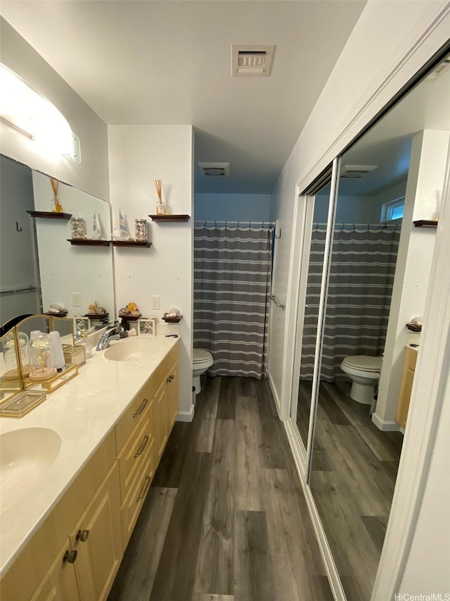 91-1001 Keaunui Dr Unit 441, Ewa Beach, HI 96706 - full bathroom featuring toilet, wood finished floors, and double vanity