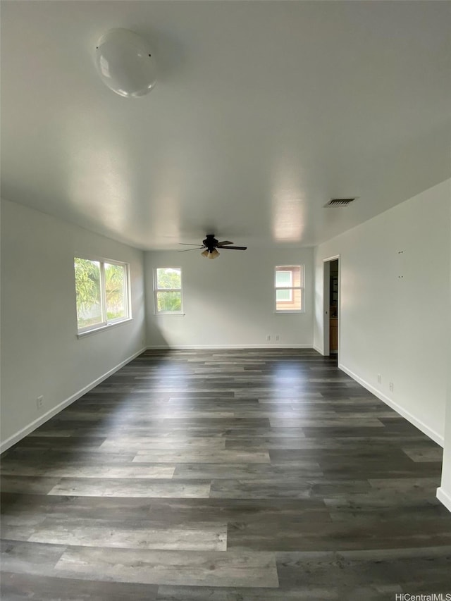 91-1001 Keaunui Dr Unit 441, Ewa Beach, HI 96706 - unfurnished room with ceiling fan, healthy amount of natural light, baseboards, and dark wood-type flooring