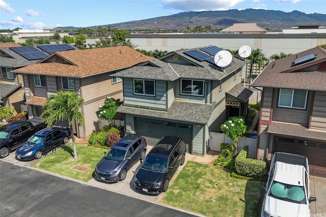 91-1001 Keaunui Dr Unit 441, Ewa Beach, HI 96706 - view of front of house featuring roof with shingles, a mountain view, driveway, solar panels, and an attached garage