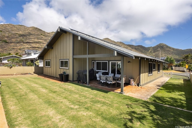 7549 Puumahoe Pl, Honolulu, HI 96825 - rear view of house featuring board and batten siding, a mountain view, and a patio area