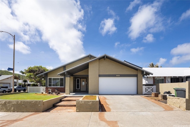 7549 Puumahoe Pl, Honolulu, HI 96825 - view of front of property featuring stucco siding, a garage, and driveway