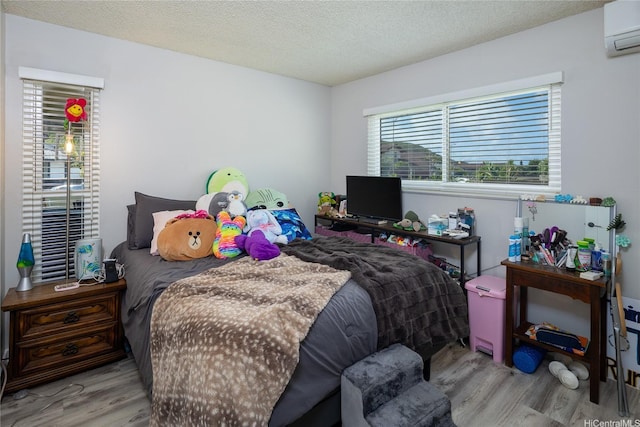 7549 Puumahoe Pl, Honolulu, HI 96825 - bedroom featuring a wall unit AC, wood finished floors, and a textured ceiling