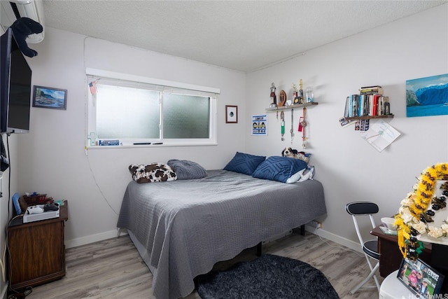 7549 Puumahoe Pl, Honolulu, HI 96825 - bedroom featuring wood finished floors, baseboards, and a textured ceiling
