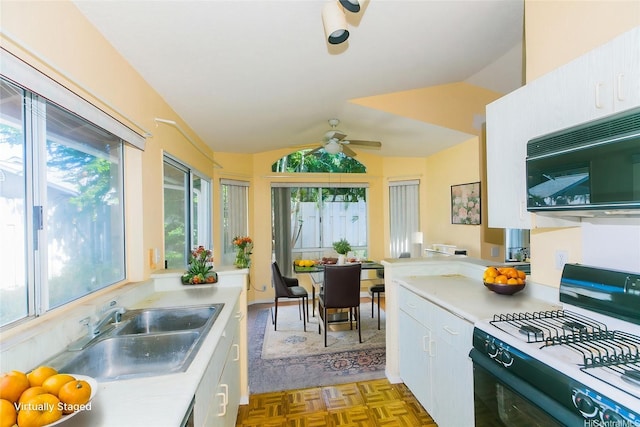 91-1006 Wahineomao Pl, Ewa Beach, HI 96706 - kitchen with range with gas cooktop, black microwave, plenty of natural light, light countertops, and lofted ceiling