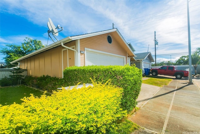 91-1006 Wahineomao Pl, Ewa Beach, HI 96706 - view of property exterior with board and batten siding, a garage, and an outdoor structure