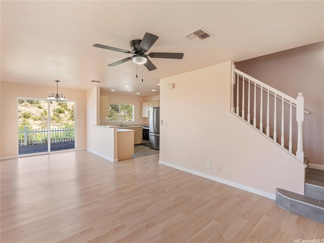 92-308 Palaulau Pl Unit 70, Kapolei, HI 96707 - unfurnished living room with a chandelier, light wood-style flooring, baseboards, a ceiling fan, and recessed lighting